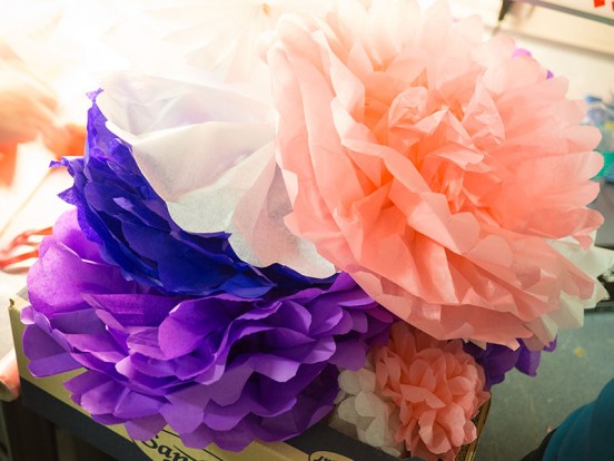 This picture shows a stack of the biggest puffy paper flowers, which are bigger than an adult's head.