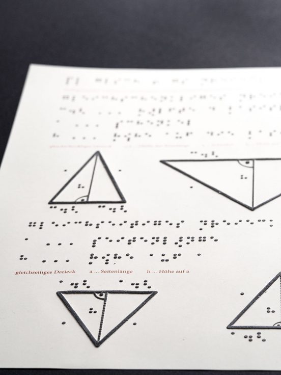A Page of the Pythagoras chapter. It has labelled tactile triangles. The text is available both in Braille and in red for readers that cannot read braille. This is the first finished page from the short test chapter we are using to test the basic design.